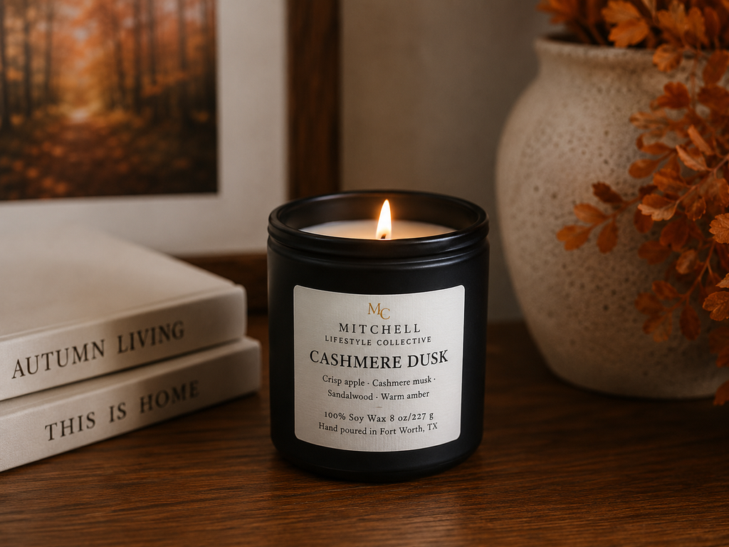 Cashmere Dusk soy candle in a matte vessel, lit, on a styled tabletop