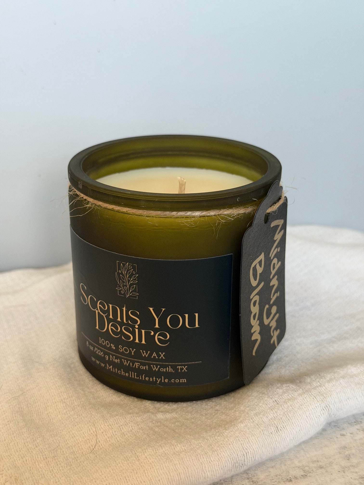 Midnight Bloom luxury candle by Scents You Desire in a moody, elegant interior