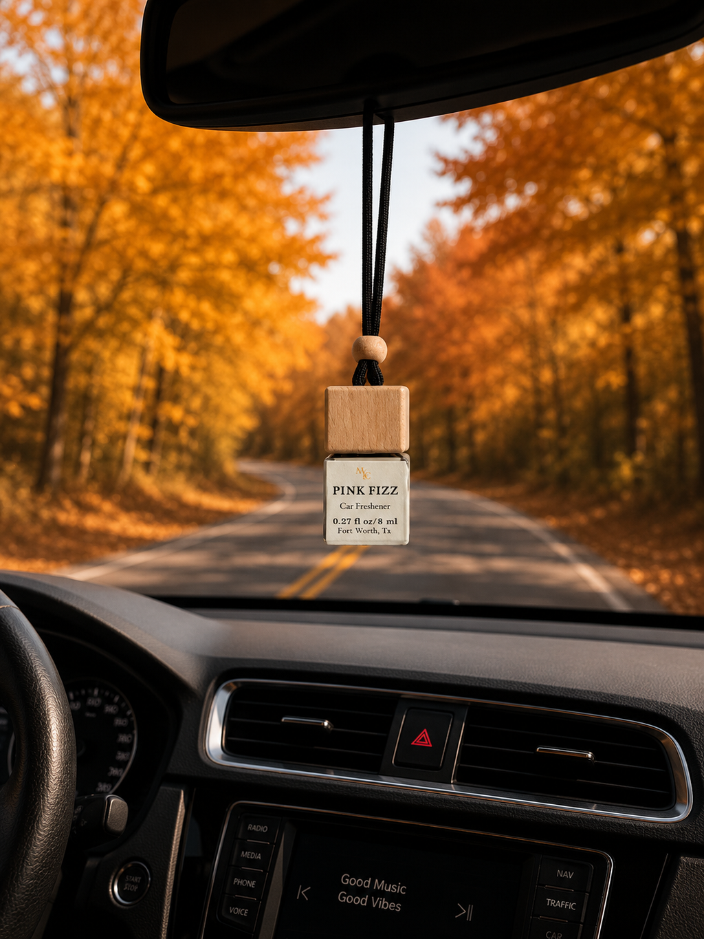 Pink Fizz car diffuser hanging from car mirror